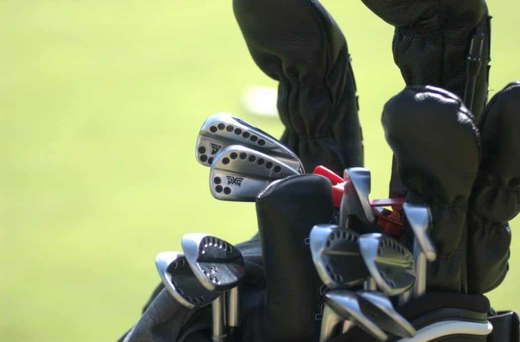 Close up photo of golf clubs in bag on the golf green